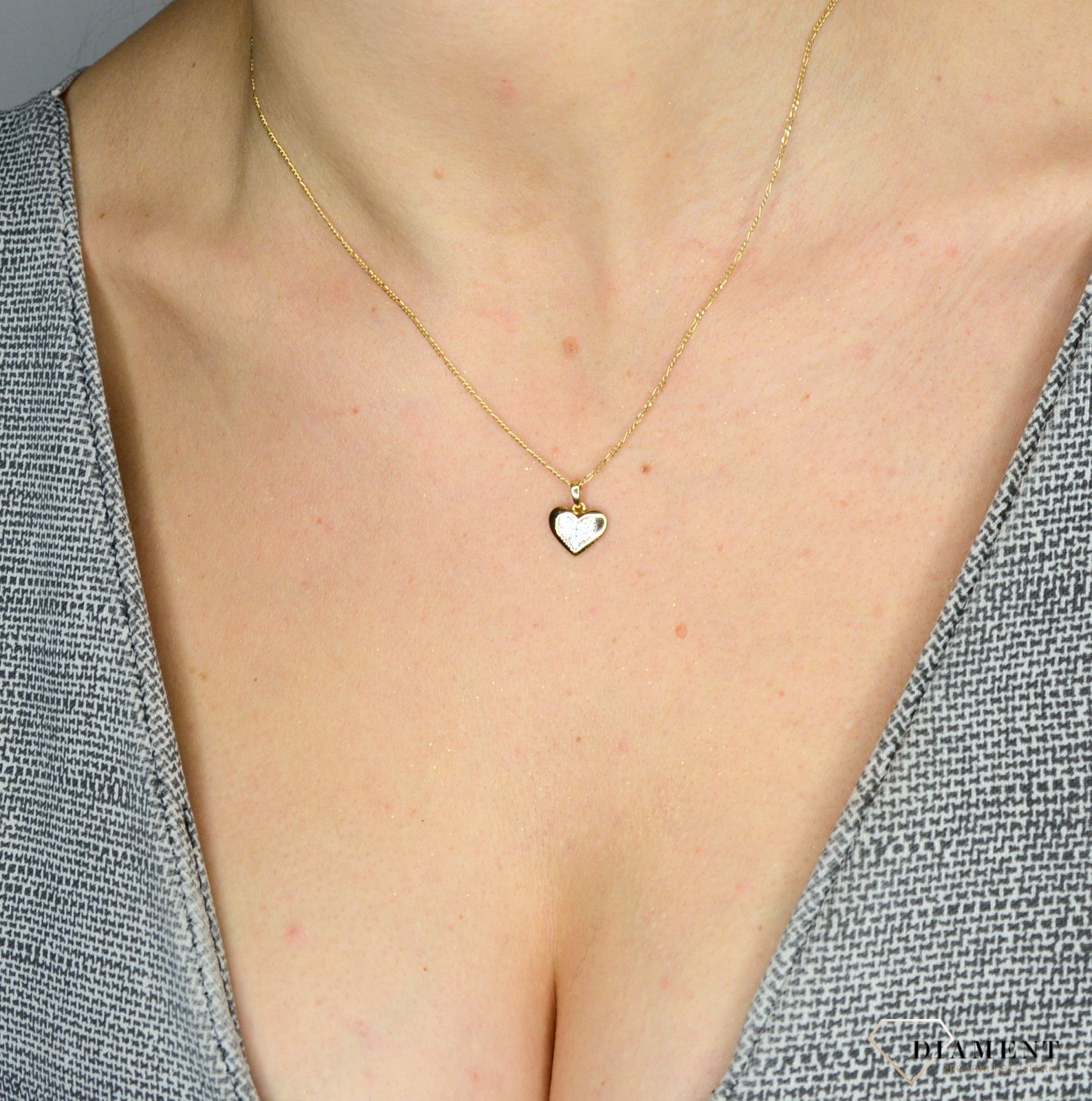 Piękna, złota zawieszka w kształcie serca, wysadzona jasnymi cyrkoniami to znany od lat, ponadczasowy i symboliczny motyw kobiecej biżuterii..jpg