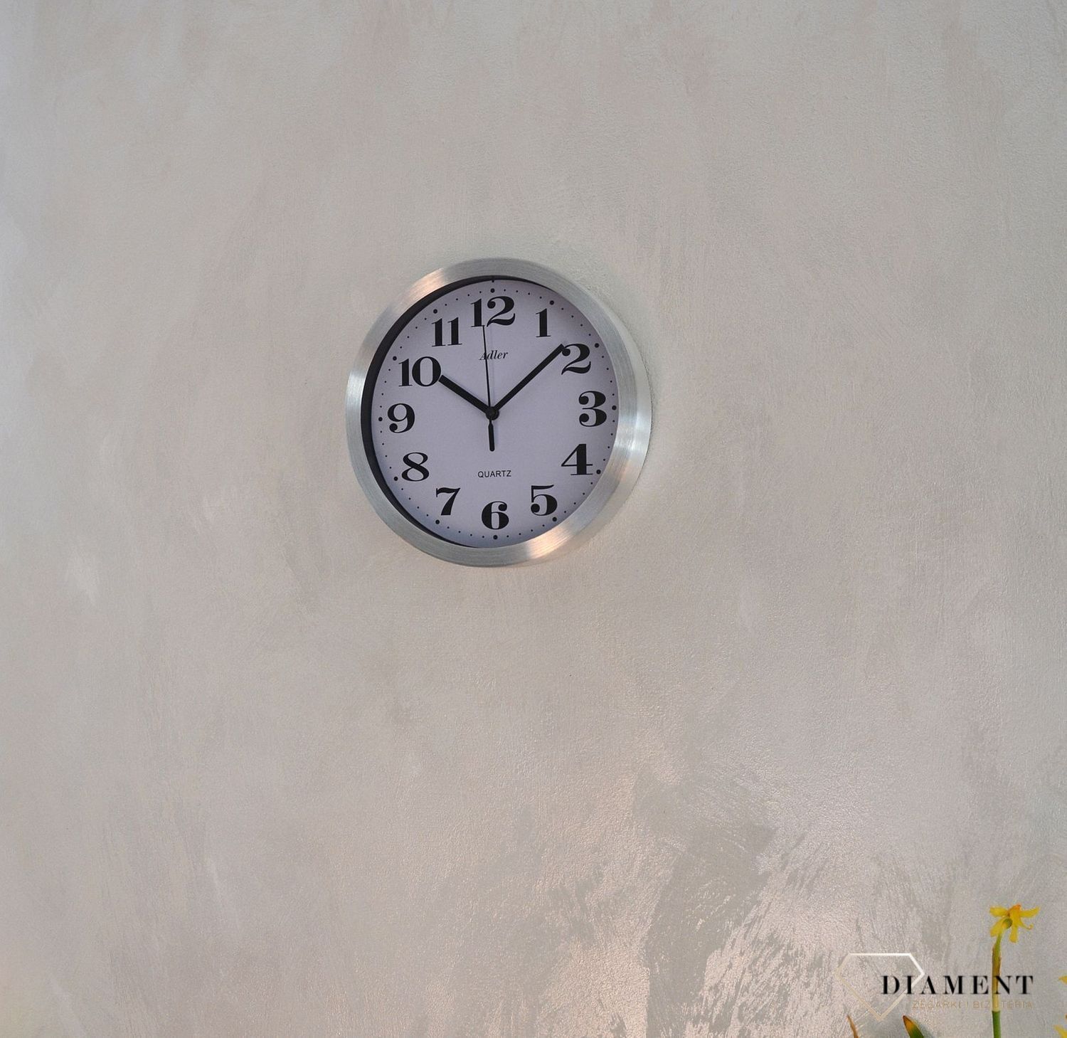 Zegar ścienny okrągły ADLER srebrny 30087. Zegar ścienny aluminiowy w klasycznym wydaniu. Tarcza zegara w kolorze białym z czarnym cyframi arabskimi i wskazówkami. Zegar ścienny zasilany za pomocą baterii. Zegar na ścianę.  (1).JPG
