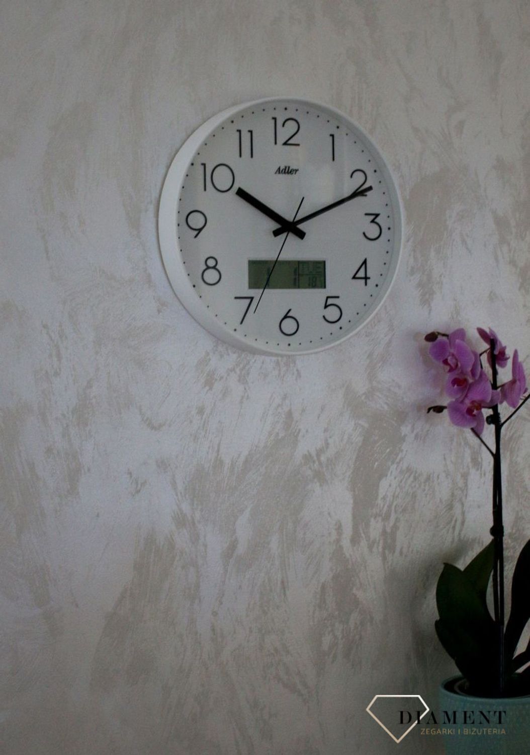 Zegar ścienny okrągły Adler Biały z datownikiem i termometrem 30173. Zegar ścienny Adler okrągły wyposażony jest w kwarcowy mechanizm, zasilany za pomocą baterii (1).JPG