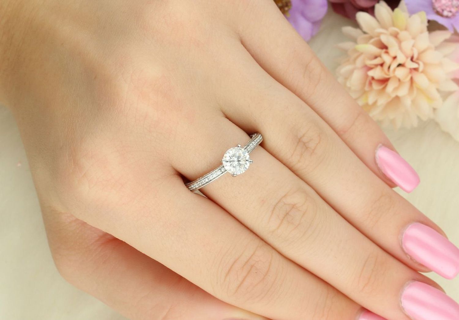 Elegancki srebrny pierścionek z centralnym moissanitem w czterech łapkach i dodatkowymi kamieniami po bokach. Ponadczasowy design idealny na prezent i wyjątkowe okazje (1).jpg