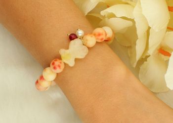 Bransoletka damska stalowa BR039 na gumce z kolorowymi koralikami w odcieniach czerwieni, pomarańczu i żółtego. Ozdobiona uroczym żółtym misiem. Modna, wygodna i idealna na co dzień oraz lato.22.jpg