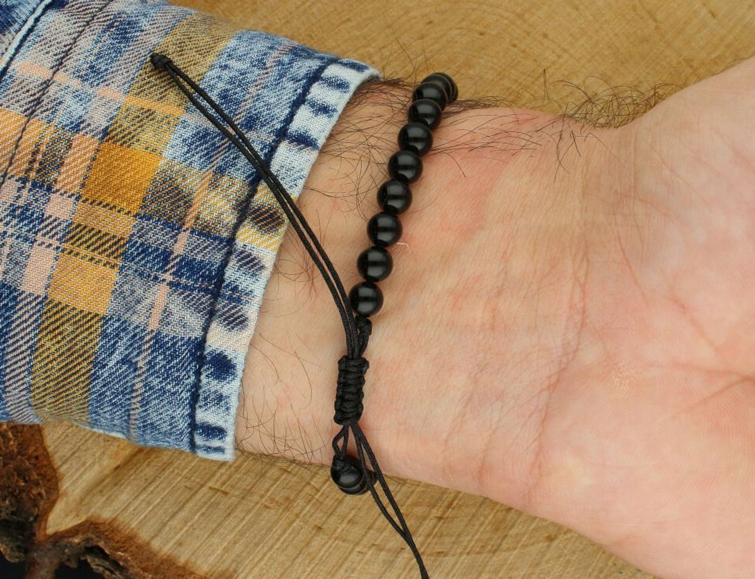 Pozłacana bransoletka „Najlepszy Tata” ze srebra 925 na czarnym sznurku z onyksami. Regulowana długość, elegancka blaszka 5,9 × 41,7 mm. Idealny prezent dla taty na każdą okazję.1.jpg