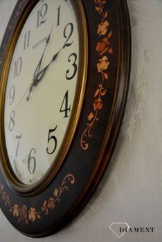 Zegar na ścianę Rhythm drewniany owalny z wzorem CMG298NR06. Owalny duży zegar ścienny w kolorze brązowym. Obudowa wykonana z wytrzymałego drewna w kolorze brązowym (1).JPG