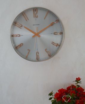 Zegar ścienny do salonu srebrny Rhythm z różowym złotem CMG554NR19. Zegar ścienny do salonu zachowany w nowoczesnej formie. Okrągła obudowa wykonana z wysokiej jakości materiału metalu (2).JPG