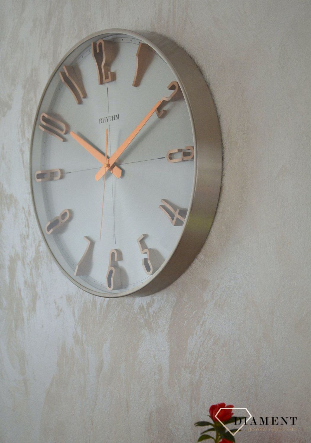 Zegar ścienny do salonu srebrny Rhythm z różowym złotem CMG554NR19.jpg