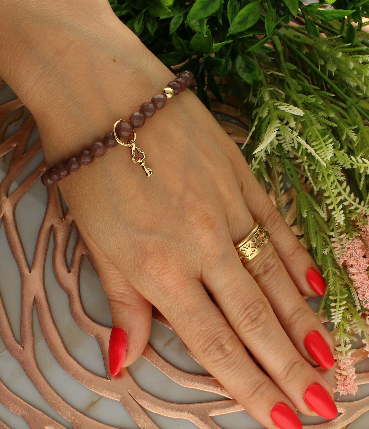 Bransoletka damska na gumce brązowe koraliki z pozłacanym kluczem DIA-BRA-5743-INNE. Bransoletka damska koraliki. Bransoletka damska brązowa. Bransoletka damska z kluczem. Bransoletka damska na gumce. Bransoletka damska idealn (1).jpg