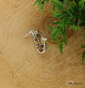 Srebrna broszka w kształcie Saksofonu ozdobiony bursztynem DIA-BRO-7057-925.   Broszka z możliwością zawieszenia na łańcuszek. Broszkę można zestawić z pozostałą biżuterią i tworzyć modne sety (2).jpg