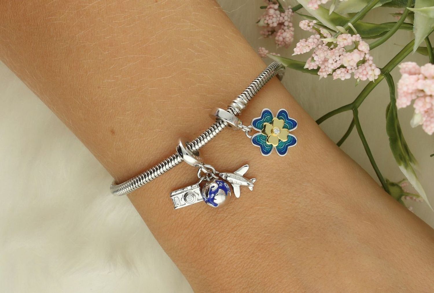 Srebrny charms 925 w kształcie czterolistnej koniczyny z błękitno-zieloną emalią, złoconym środkiem i białą cyrkonią. Symbol szczęścia – idealny na prezent! Model DIA-CHA-IM0740525CH-925.1.jpg