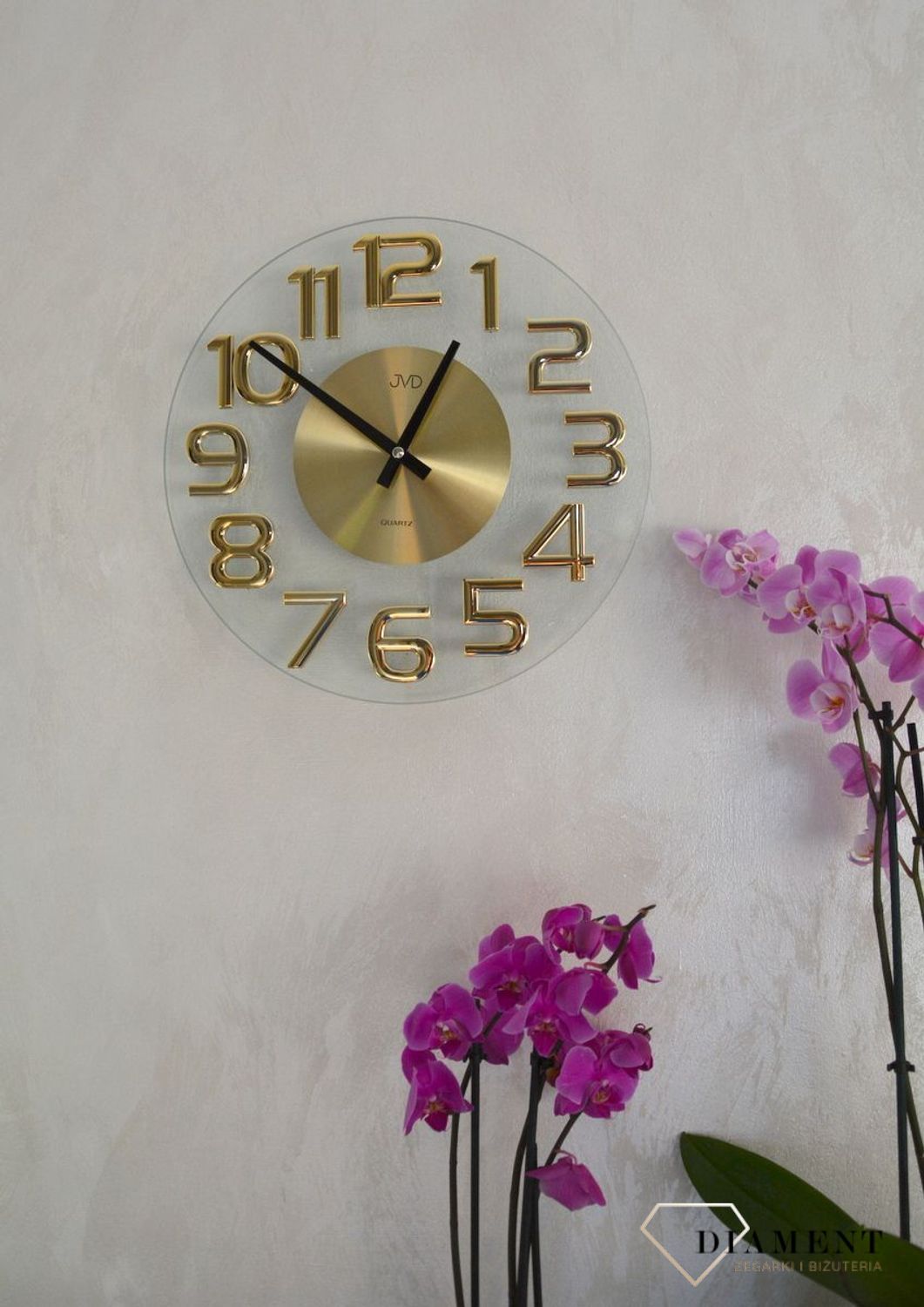 Zegar na ścianę szklany JVD ze złotymi cyframi HT098.1 to ozdobny, prosty zegar pasujący do każdego wnętrza. Ciekawa stylizacja zegara w kolorze złotym (2).JPG