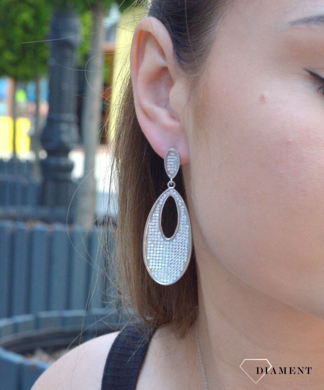 Kolczyki srebrne wiszące do ślubu w cyrkonie to nieskazitelne srebrne kolczyki w kształcie owalnym z białymi cyrkoniami. Zapięcie z tyłu na sztyfcie. Oryginalne i w nowoczesnym stylu podkreślające kobiecość.jpg