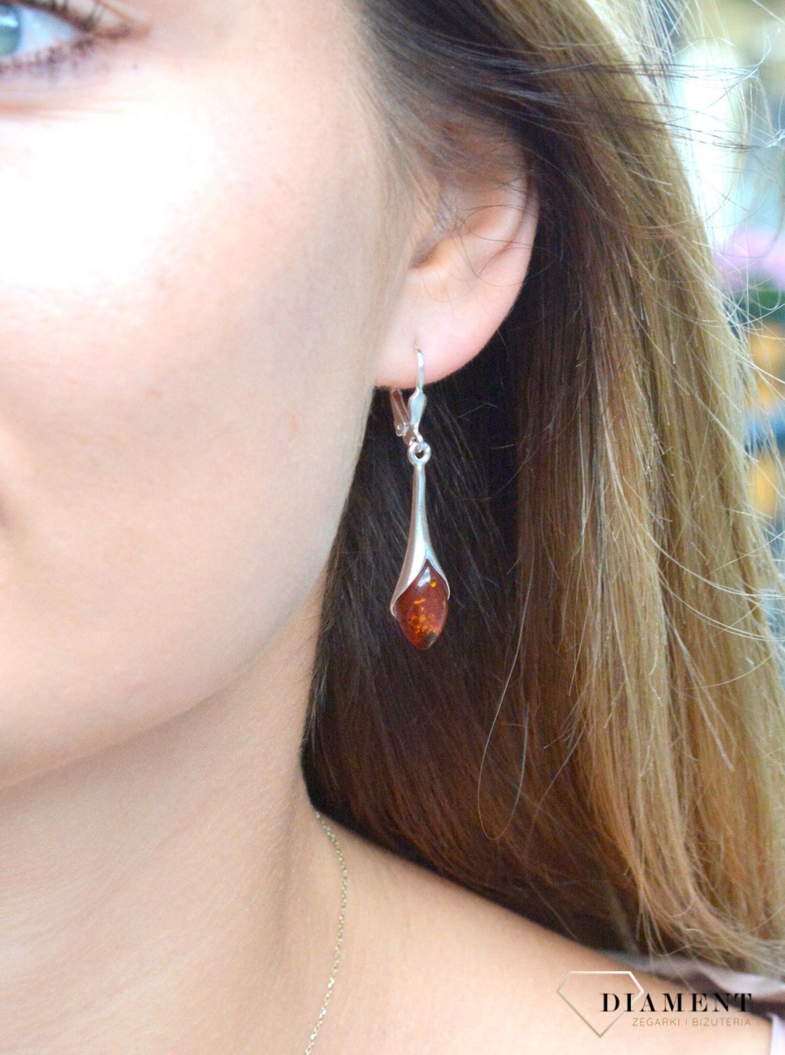 Srebrne kolczyki wiszące damskie z bursztynem DIA-KLC-7102A-925. Charakteryzują się stylem wiszącym i zawieszone są na tradycyjnych biglach angielskich. Srebrne kolczyki z bursztynem to modelem bardzo ciekawy, pięknie podkreś.jpg