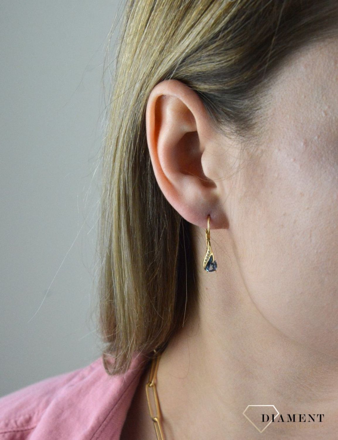 Złote kolczyki 375 wiszące łezki z błękitną cyrkonią DIA-KLC-7759-375. Złote kolczyki wykonane z najwyższej jakości żółtego złota, próba 375, waga około 2,06 gram. Kolczyki w minimalistycznym stylu, wpisujące się w obecne tren.jpg