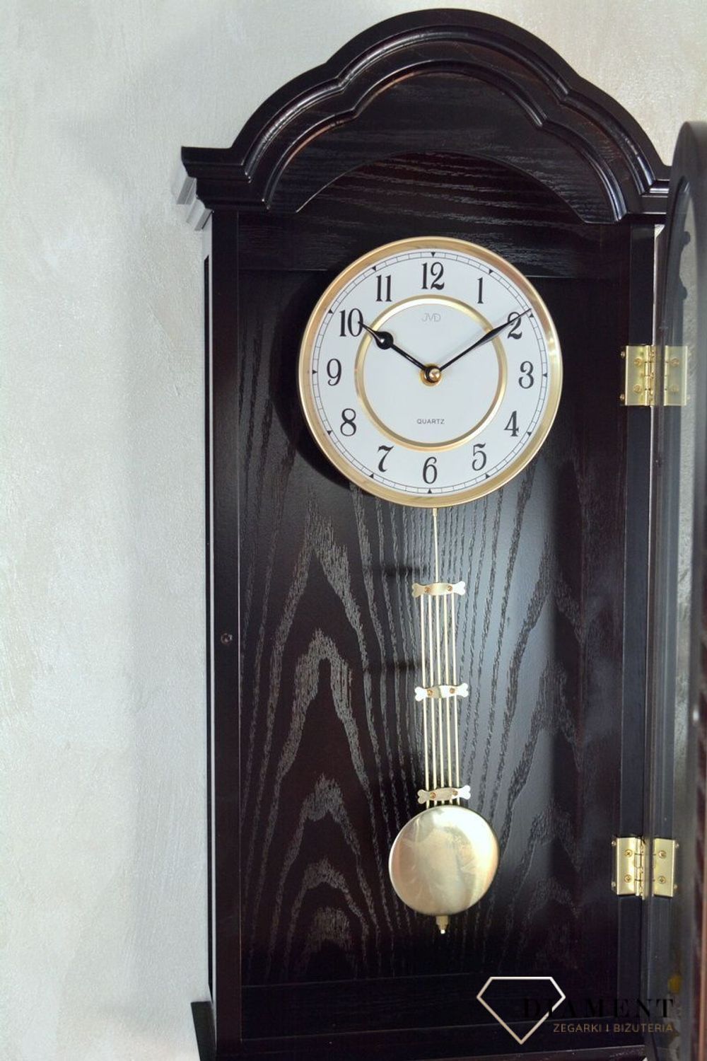 Zegar ścienny z wahadłem ' Drewniany zegar' JVD N9353.1 wyposażony jest w kwarcowy mechanizm, zasilany za pomocą baterii. Posiada bardzo wysoką dokładność mierzenia czasu +- 10 sekund w przeciągu 30 dni..png