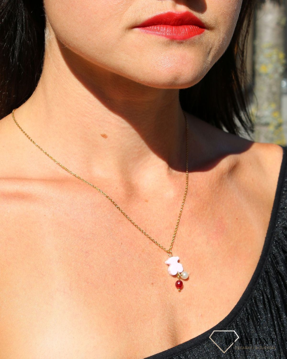 Stalowy pozłacany naszyjnik z różowym misiem i koralikami DIA-NSZ-3310-STAL. Elementem ozdobnym w naszyjniku jest zawieszka w kształcie misia w kolorze różowym oraz dołączone do niego koraliki w kolorze białym (1).JPG