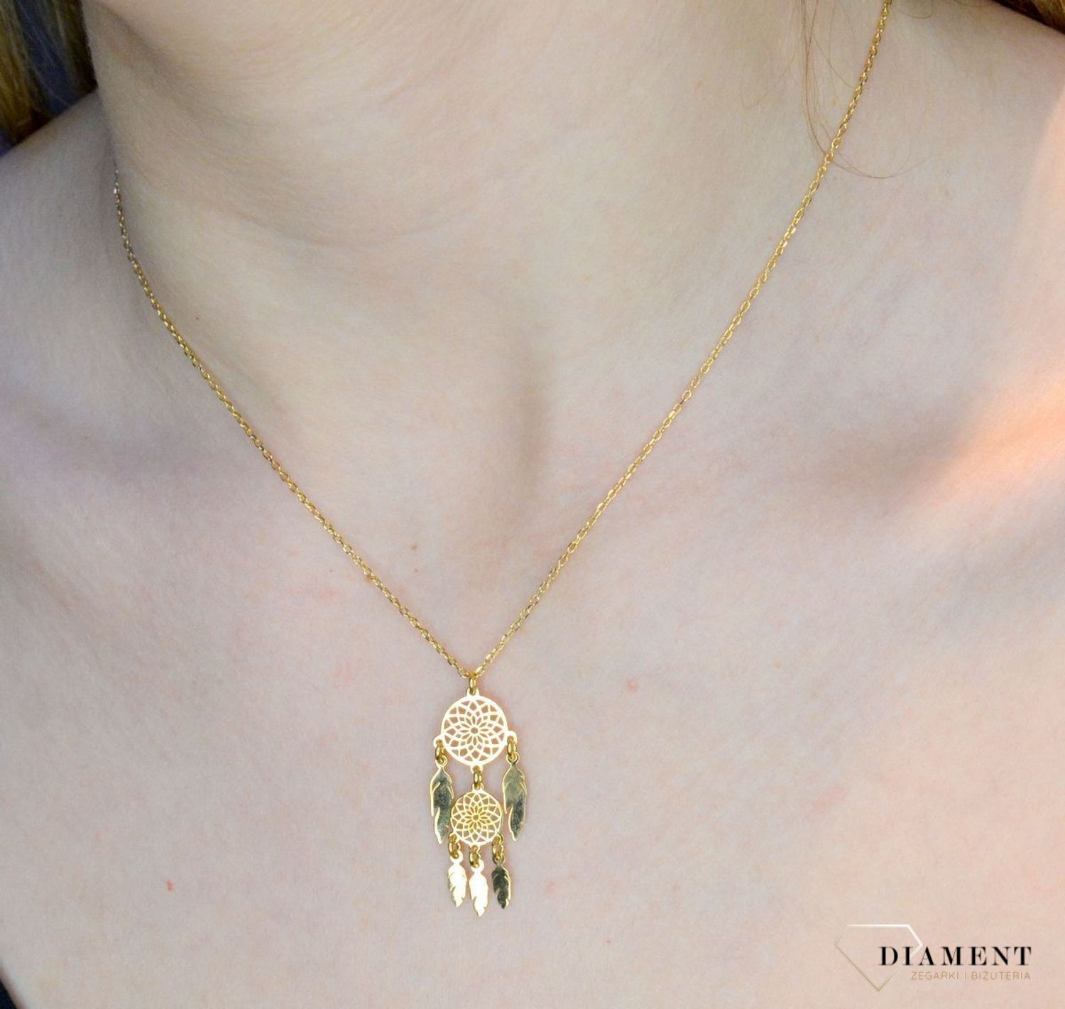 Pozłacany naszyjnik damski z elementem ozdobnym łapacz snów DIA-NSZ-8556-925. Naszyjnik będzie świetnym dodatkiem pasującym do wielu stylizacji. Jest idealnym pomysłem na prezent.Naszyjnik srebrny z połyskującymi elementami..jpg