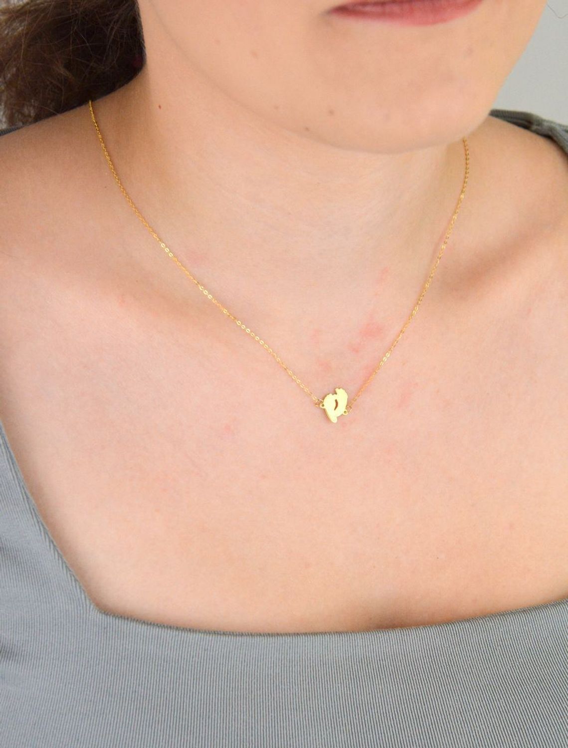 Złoty naszyjnik damski próby 333 z zawieszką w kształcie dwóch gładkich stópek. Długość 42+3 cm, splot ankier, waga 0,90 g. Symboliczna i delikatna biżuteria o wyjątkowym znaczeniu.1.jpg