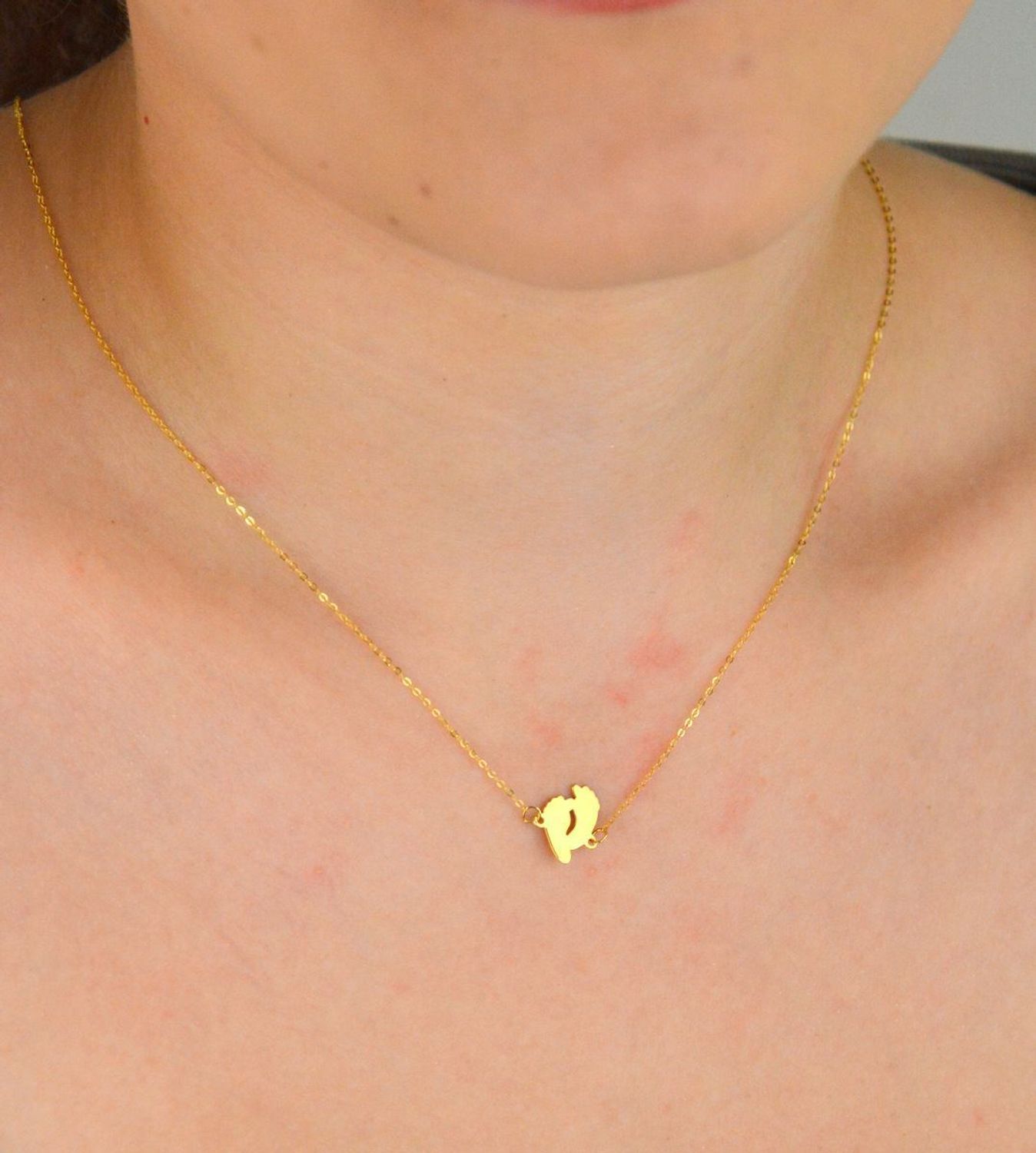 Złoty naszyjnik damski próby 333 z zawieszką w kształcie dwóch gładkich stópek. Długość 42+3 cm, splot ankier, waga 0,90 g. Symboliczna i delikatna biżuteria o wyjątkowym znaczeniu.1.jpg