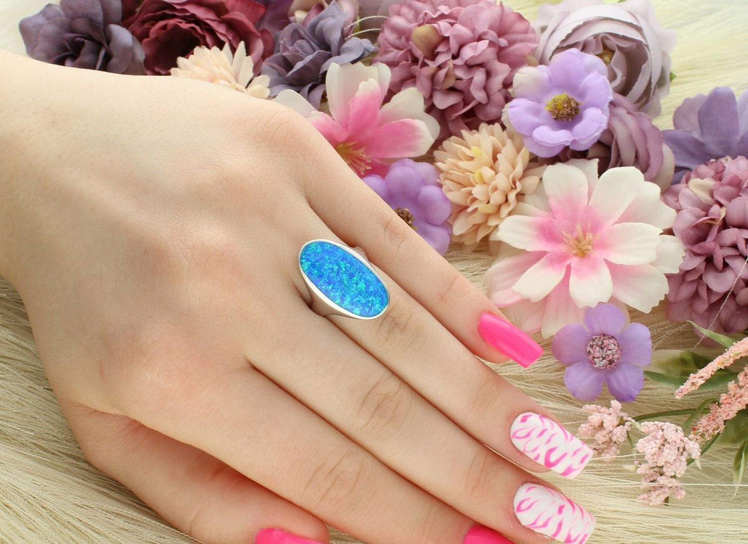 Srebrny pierścionek damski z niebieskim opalem syntetycznym. Owalna ozdoba 2,2 x 1,2 cm, solidna szyna 4 mm, waga 5,18 g. Stylowy i przyciągający wzrok dodatek.1.jpg