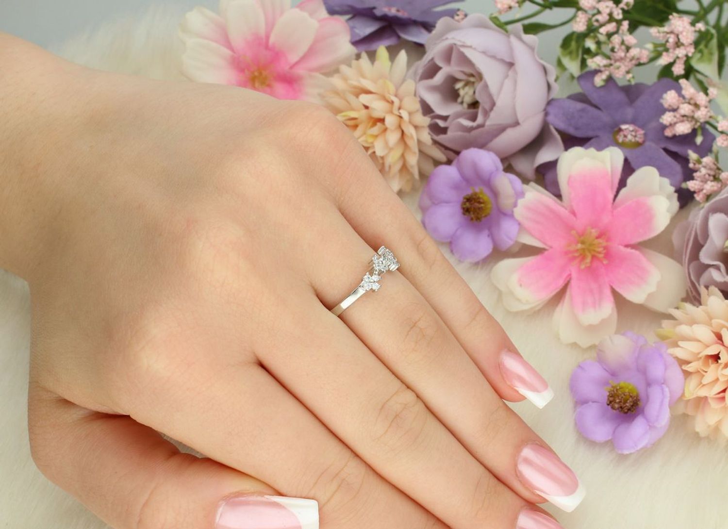 Srebrny pierścionek damski 925 DIA-PRS-13390-925 z siedmioma kwiatkami ozdobionymi cyrkoniami. Szerokość 4 mm, szyna 2 mm, waga 1,90 g. Subtelna i kobieca ozdoba dłoni.1.jpg