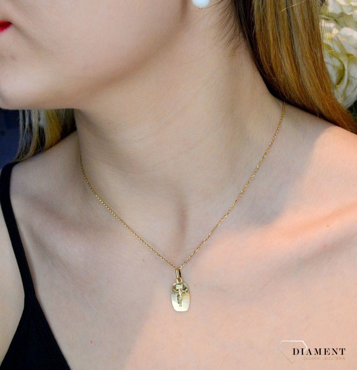 Złoty medalik 585 z wizerunkiem Jezusa na krzyżu DIA-ZAW-0474-585. Medalik będący wspaniałą pamiątką i prezentem z okazji chrztu, komunii czy bierzmowania. Zawieszka wykonana ze złota próby 585 Piękna biżuteria o bogatej symbo.jpg