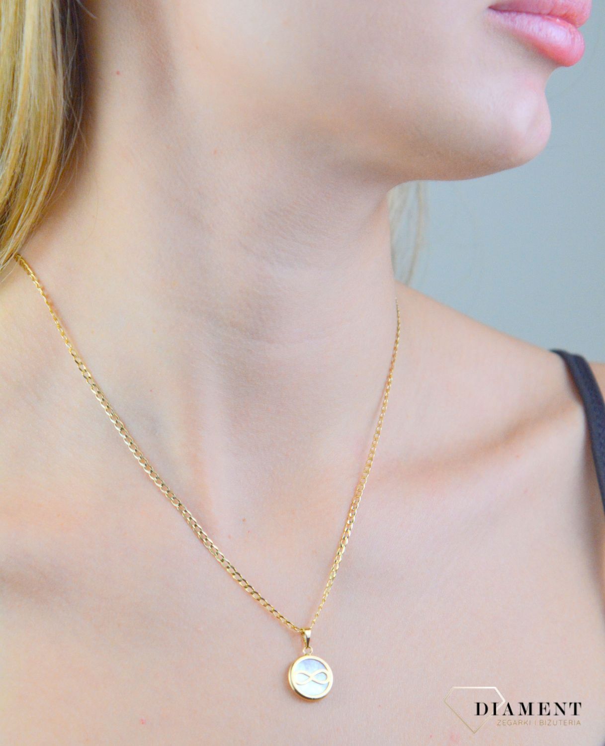 Zawieszka złota nieskończoność z masą perłową próba 585, DIA-ZAW-12101-585 Piękna zawieszka w kształcie kółeczko z nieskończonością, wykonana ze złota próby 585.1.jpg