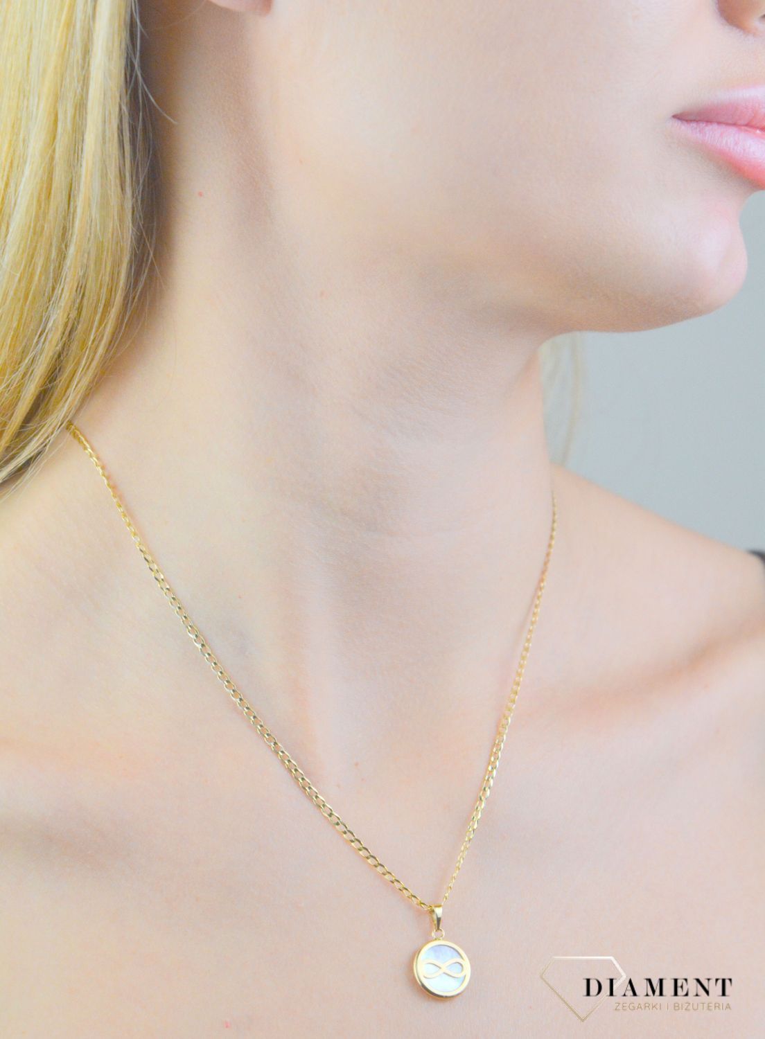 Zawieszka złota nieskończoność z masą perłową próba 585, DIA-ZAW-12101-585 Piękna zawieszka w kształcie kółeczko z nieskończonością, wykonana ze złota próby 585.1.jpg