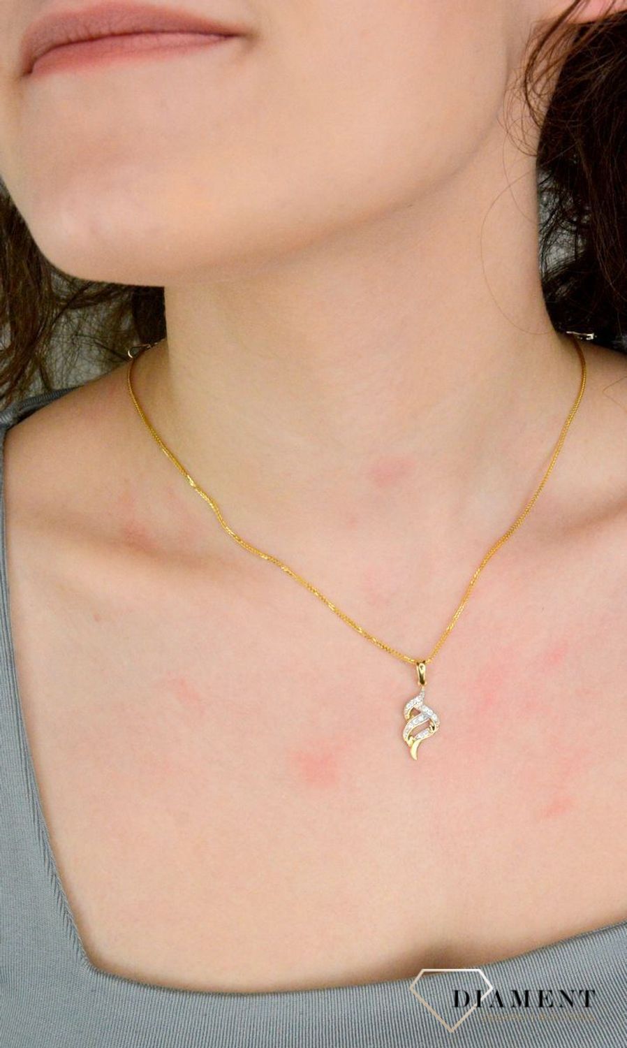 Zawieszka złota cyrkonie próba 585, DIA-ZAW-12630-585 Wisiorek został wykonany z wysokiej jakości złota próby 585. Złoto to jeden z najpopularniejszych kruszców, cenione przez kobiety na całym.jpg