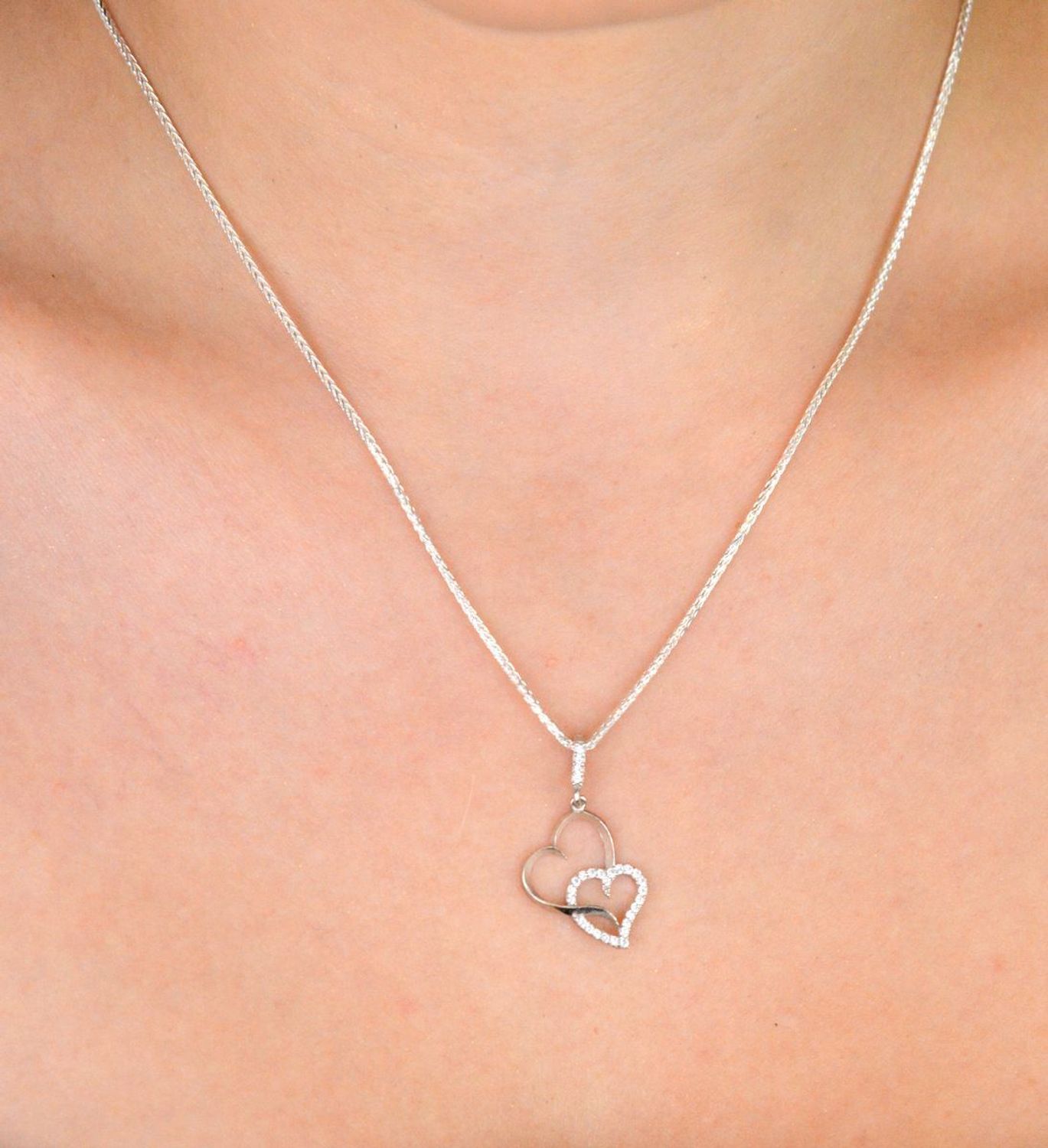 Romantyczna zawieszka srebrna DIA-ZAW-13337-925 z dwoma splecionymi sercami, jedno zdobione cyrkoniami. Srebro próby 925, długość 2,8 cm, szerokość 1,3 cm, waga 0,90 g.1.jpg