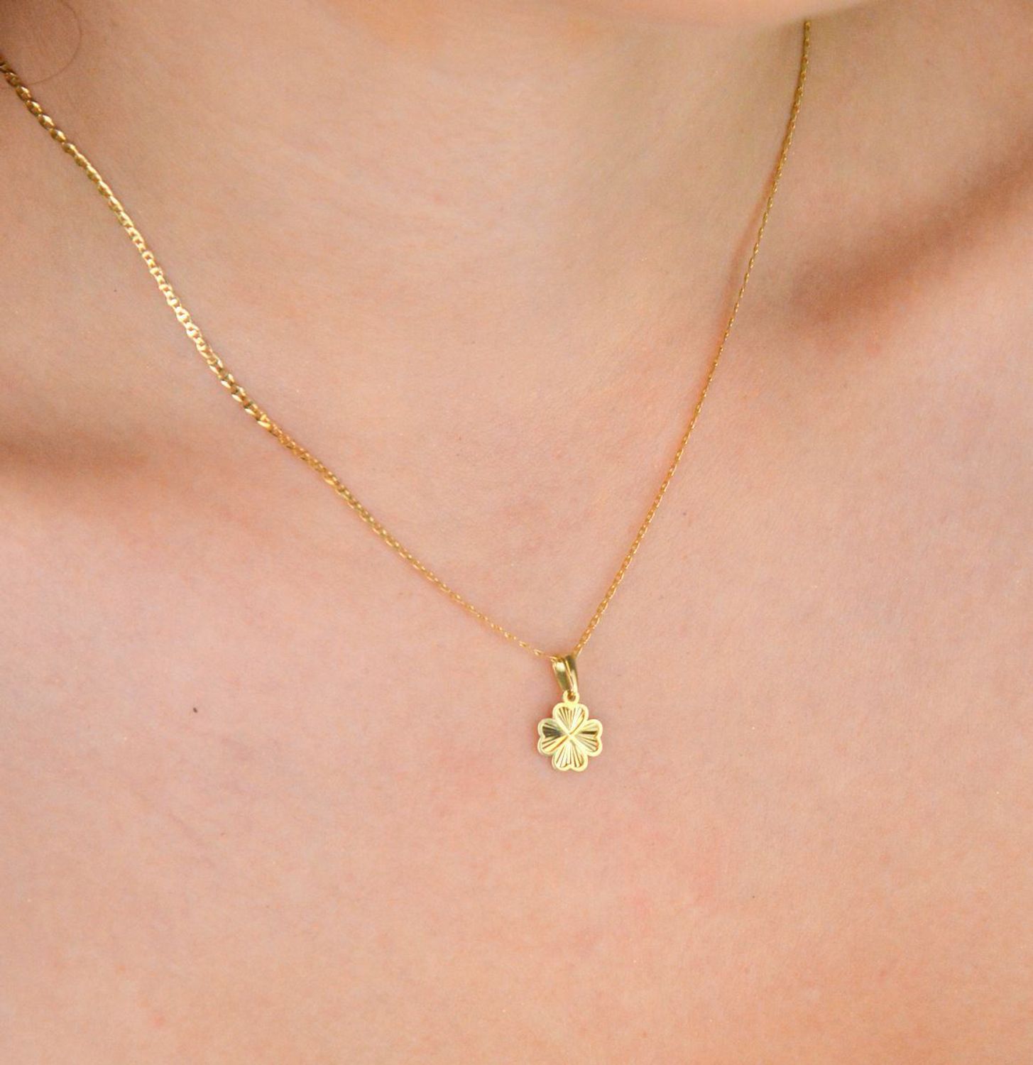 Złota zawieszka próby 585 w kształcie koniczynki z ozdobnym wzorem. Długość 1,5 cm, szerokość 9 mm. Lekka, stylowa i pełna uroku – idealna na szczęście.1.jpg