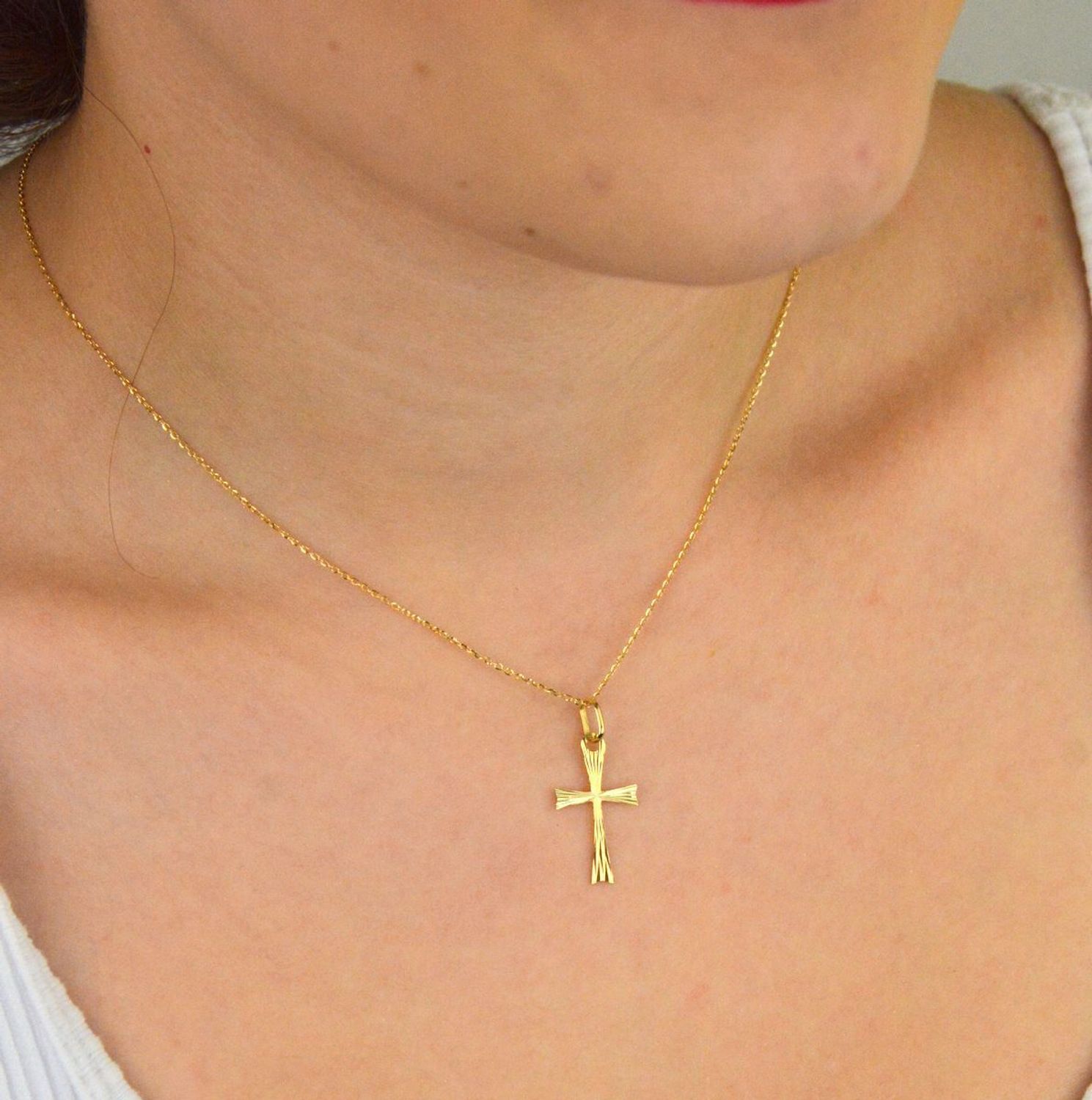 Zawieszka złota DIA-ZAW-13759-585 – krzyż grawerowany. Wymiary 2,5 cm x 1,3 cm, waga 0,44 g. Subtelna i elegancka biżuteria religijna, idealna na prezent.1.jpg