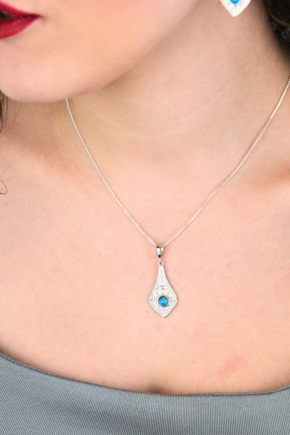 Elegancka zawieszka srebrna próby 925 w geometrycznym kształcie, zdobiona małym, okrągłym turkusem. Model DIA-ZAW-13996-925, długość z oczkiem 3,7 cm, szerokość 1,4 cm, waga 2,5 g. Idealny 1.jpg