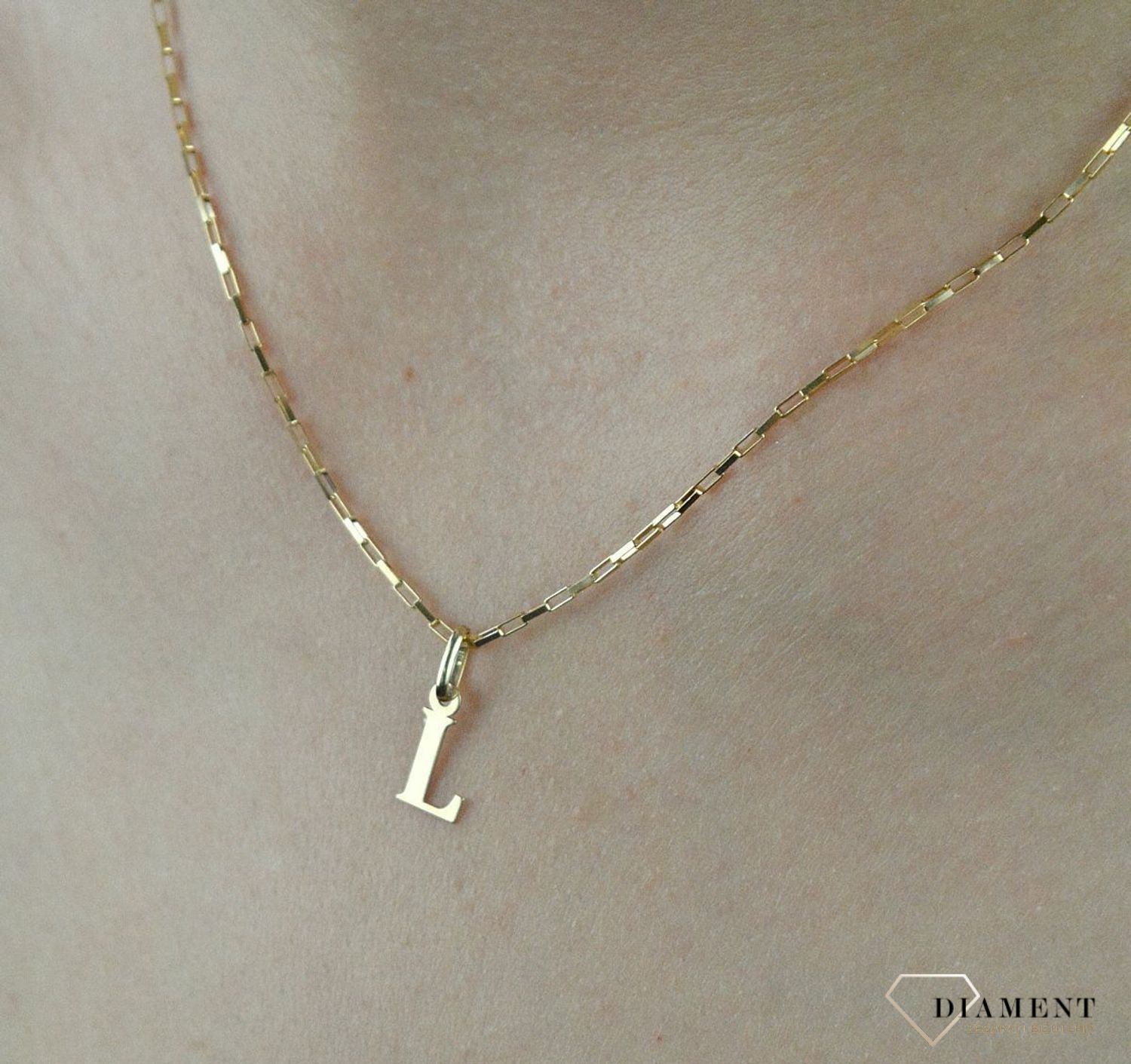 Złota zawieszka literka L 1 cm DIA-ZAW-2692L-585. Jedyna w swoim rodzaju złota zawieszka w kształcie literki L. Wisiorek został wykonany z najwyższej jakości złota próby 585. Złote literki to ostatni krzyk mody, uwielbiany prz.jpg