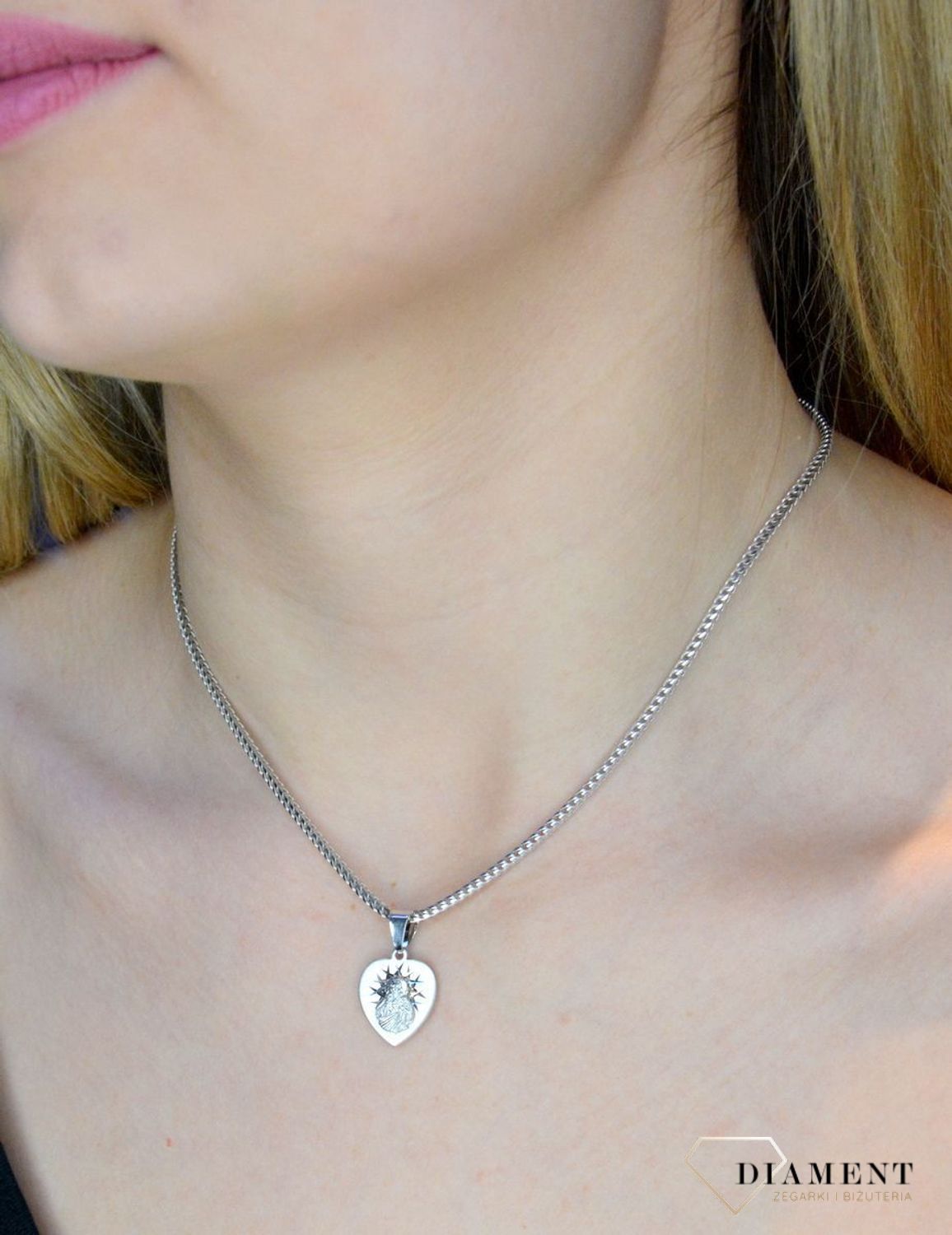 Srebrna zawieszka w kształcie serca z wizerunkiem Matki Boskiej DIA-ZAW-40245C-925. Idealnie będzie pasował do srebrny subtelnych łańcuszków. Sprawdzi się również jako idealny prezent na komunię bądź chrzciny dla dziecka.jpg