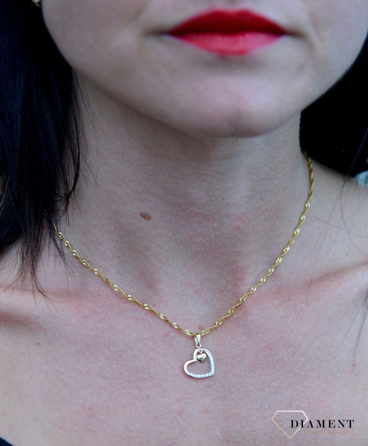 Złota zawieszka serce ozdobione cyrkonią z małym wiszącym serduszkiem DIA-ZAW-4390-585. Złota zawieszka w kształcie serca ozdobione częściowo błyszczącą cyrkonią.jpg