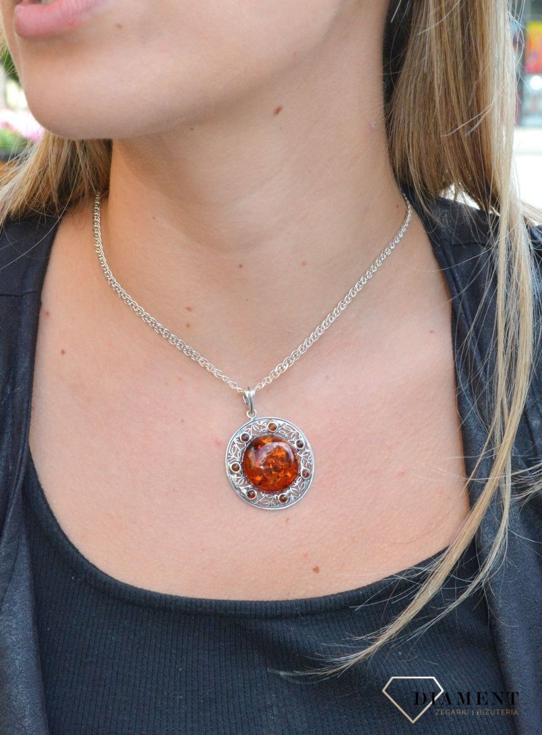 Zawieszka srebrna w okrągłym kształcie z bursztynem  DIA-ZAW-7122-925. Bursztyn wprawiono w najwyższej jakości srebro o próbie 925, kruszec od wielu setek lat symbolizujący głębię emocjonalną, duchowość i żeńską energię.jpg