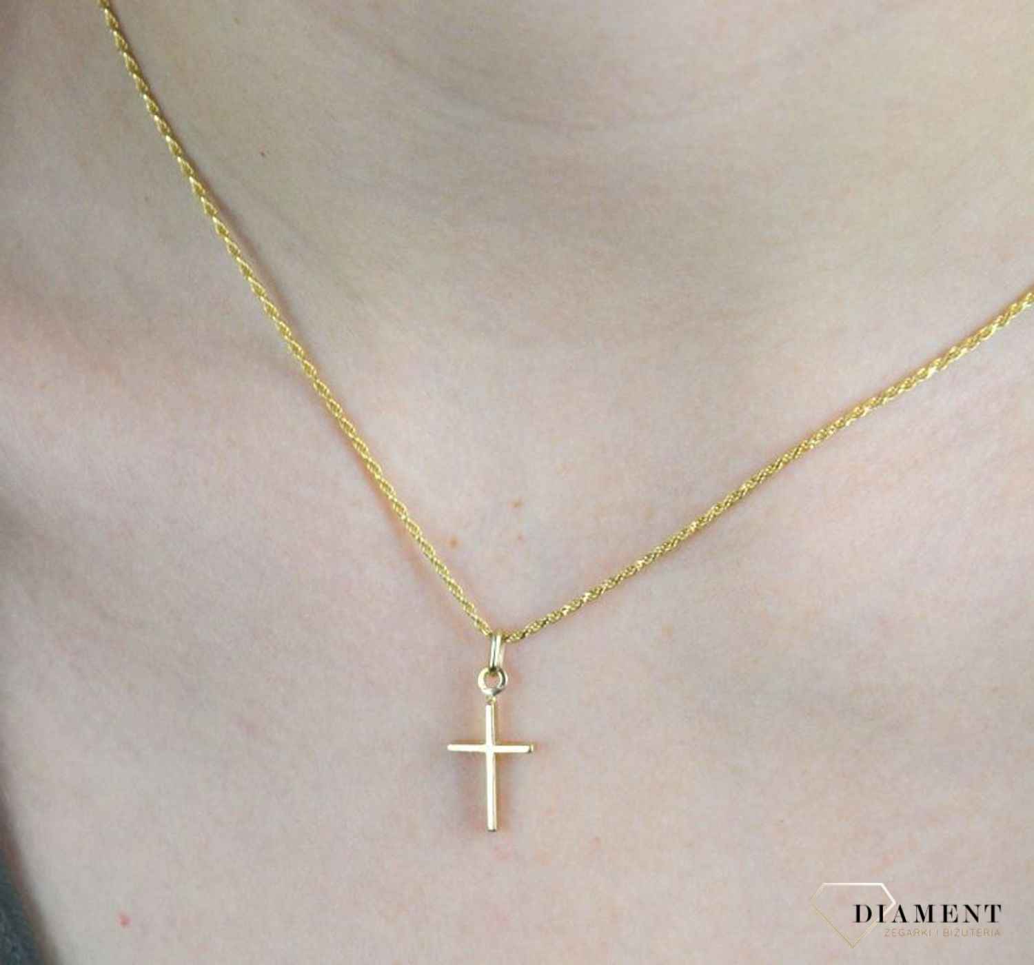 Złota zawieszka 585 delikatny krzyżyk DIA-ZAW-8089-585. Złoty wisiorek o kształcie krzyżyka  został wykonany z wysokiej próby złota 585 w kolorze żółtego złota. Zawieszka wykonana z niezwykłą starannością i dbałością o szczeg.jpg