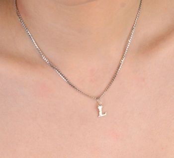 Zawieszka damska srebrna próba, Literka  L DIA-ZAW-8753-L-925 Zawieszka w kształcie literki L, wykonana z wysokiej jakości srebra próby 925, to wyjątkowy dodatek dla kobiet, które lubią wyrażać siebie poprzez  (1).JPG