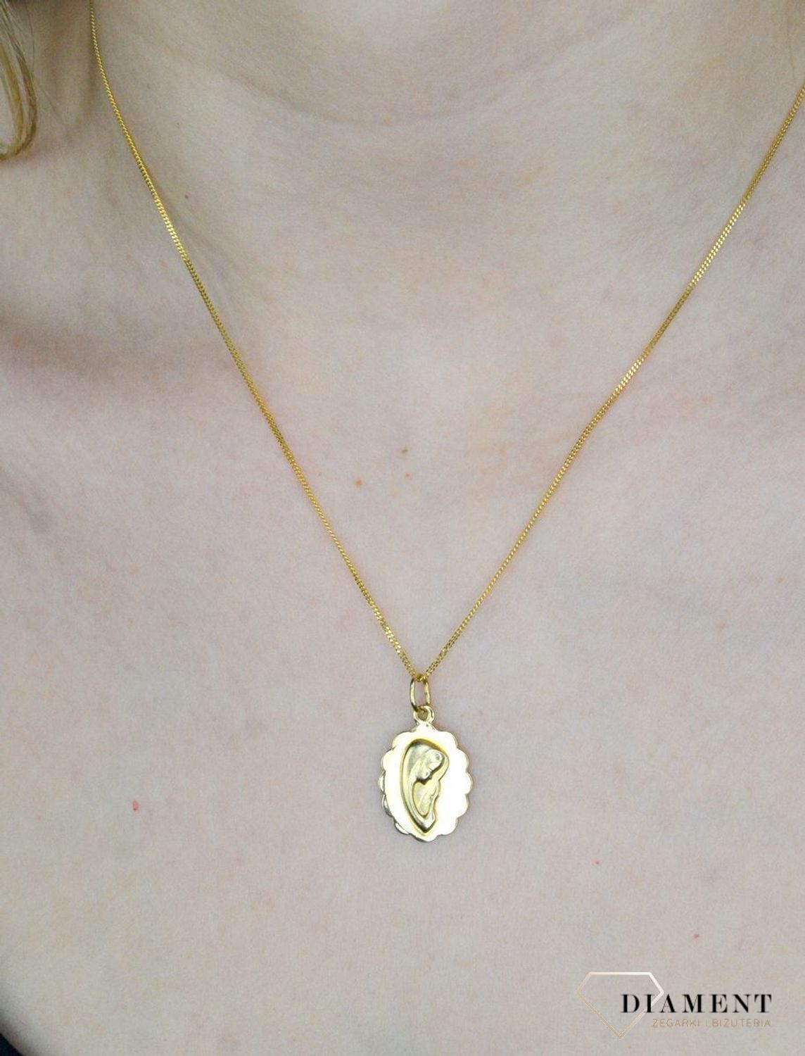 Złota zawieszka 585 medalik z wizerunkiem Matki Boskiej DIA-ZAW-9009-585. Medalik będący wspaniałą pamiątką i prezentem z okazji chrztu, komunii czy bierzmowania. Biżuteria sakralna. Metalik z Maryją..jpg