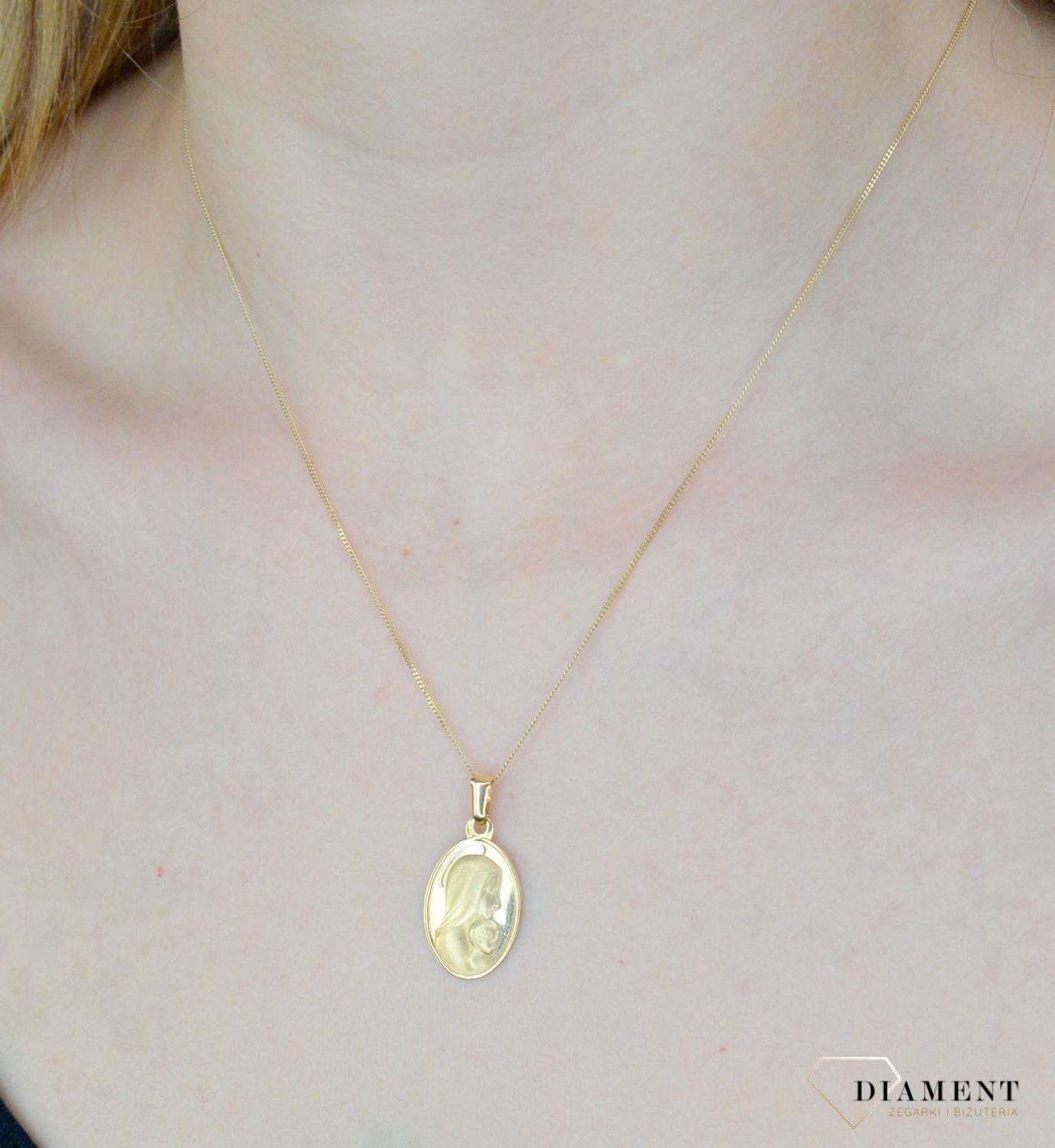 Złota zawieszka 585 owalny medalik z Matką Boską DIA-ZAW-9024-585. Medalik będący wspaniałą pamiątką i prezentem z okazji chrztu, komunii czy bierzmowania. Zawieszka wykonana ze złota próby 585 Piękna biżuteria o bogatej symbo.jpg