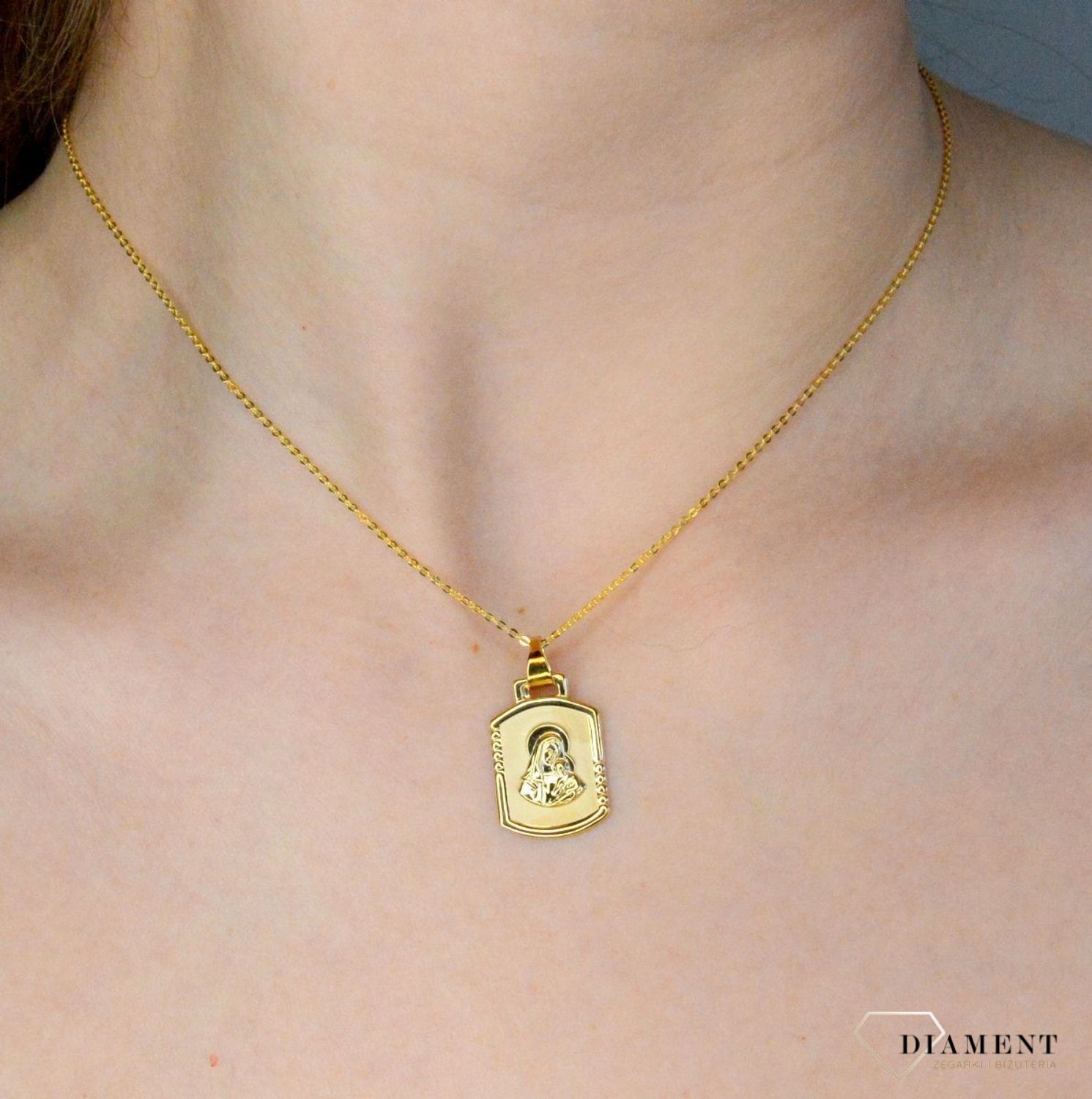 Złota zawieszka 333 medalik Matka Boska z dzieciątkiem DIA-ZAW-9137-333. Medalik będący wspaniałą pamiątką i prezentem z okazji chrztu, komunii czy bierzmowania. Zawieszka wykonana ze złota próby 333..jpg