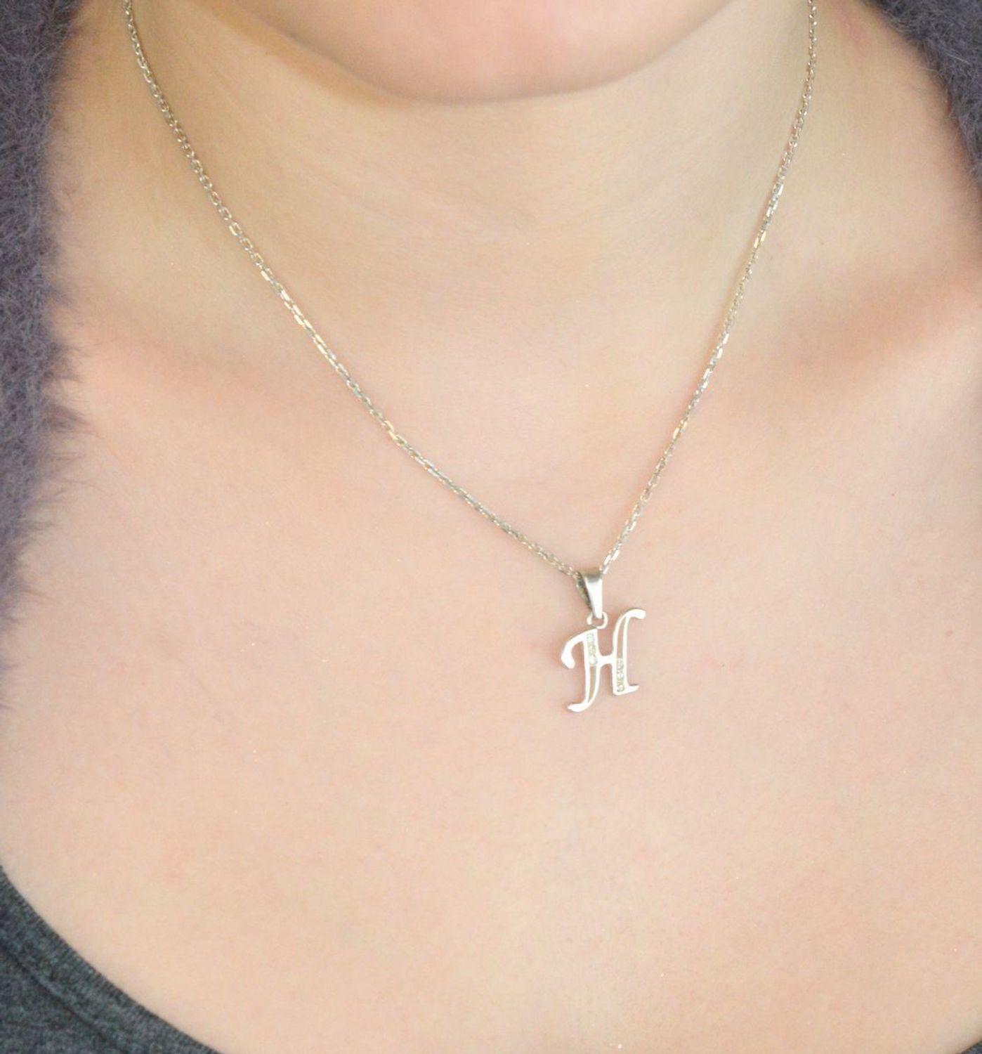 Srebrna zawieszka z literką H DIA-ZAW-LITERKA-H5-925 Subtelna i elegancka zawieszka srebrna w kształcie wielkiej, pisanej literki „H”, ozdobiona błyszczącymi cyrkoniami, które dodają jej wyjątko.jpg