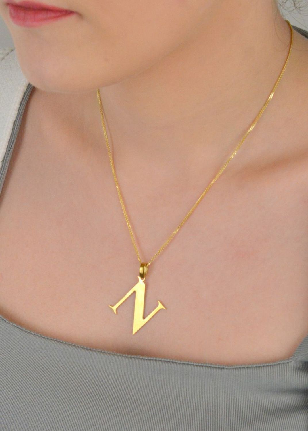Zawieszka stalowa literka N pozłacana, DIA-ZAW-ZN10819-STAL Elegancka zawieszka w kształcie literki N, wykonana ze stali nierdzewnej i pozłacana, co zapewnia jej trwałość i wyjątkowy wygląd. 1.jpg