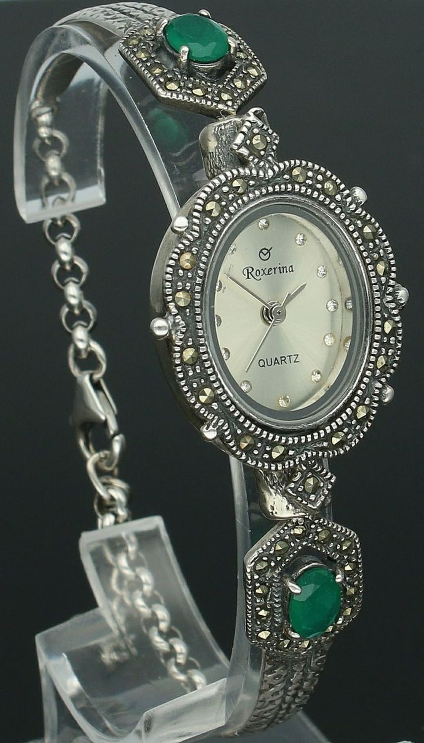 Elegancki zegarek damski ze srebra 925, waga 24 g. Owalna koperta 2,2 x 2,5 cm, bransoletka 17+3 cm, zdobiony markazytami i szmaragdami. Grawer gratis – idealny na prezent.1.jpg