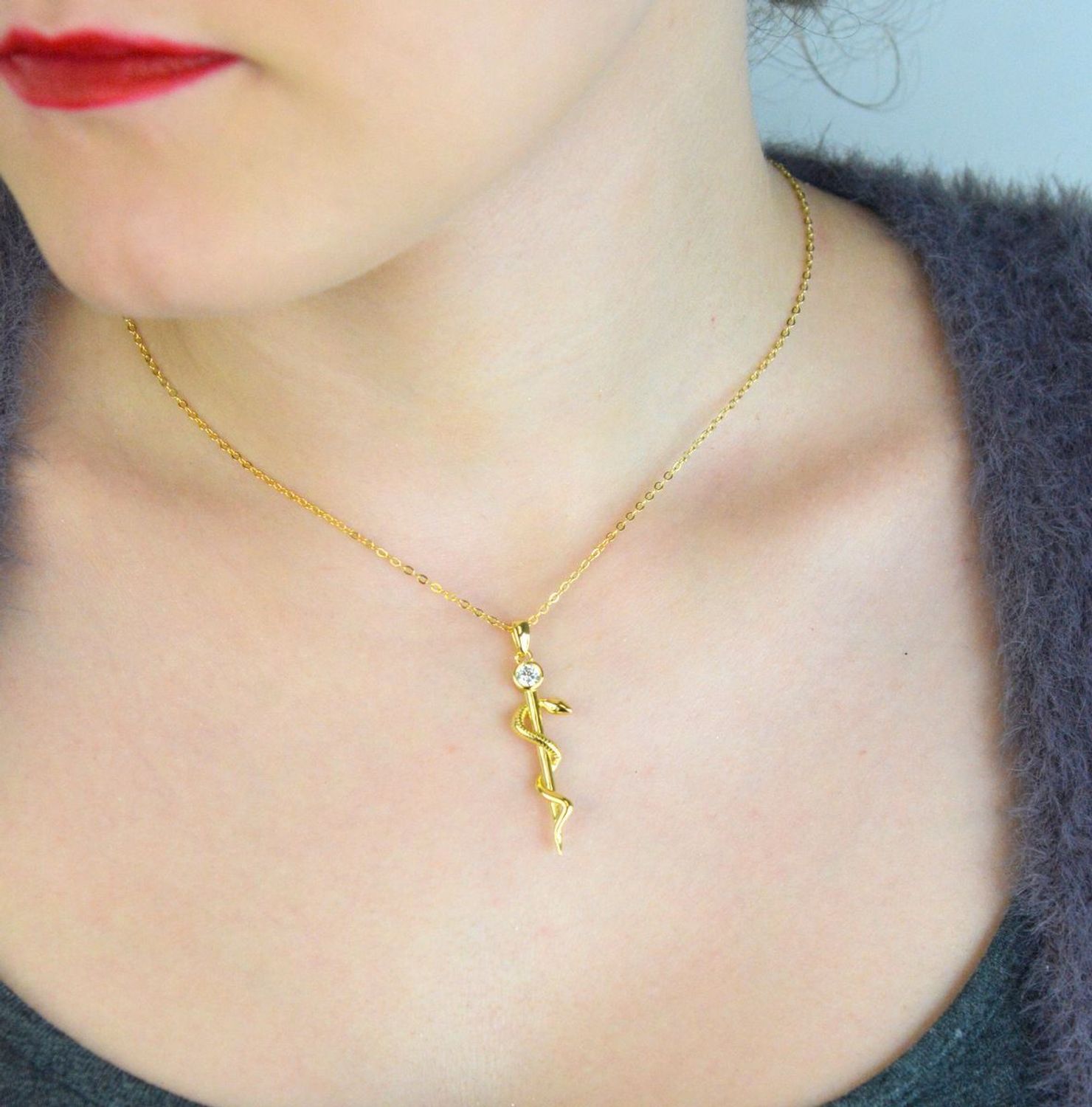 Naszyjnik srebrny JMAN0298GN z zawieszką Laska Eskulapa i białą cyrkonią. Wykonany ze srebra próby 925, długość 42+3 cm, waga 4,15 g. Idealny prezent dla lekarza, farmaceuty lub 1.jpg