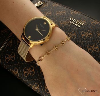 Bransoletka damska Guess celebrytka z cyrkoniami JUBB02226JWYGS. Bransoletka damska Guess w złotym kolorze z literkami ozdobnymi ułożonymi w napis Guess. Stalowa bransoletka w kolorze złotym z cyrkoniami (1).jpg