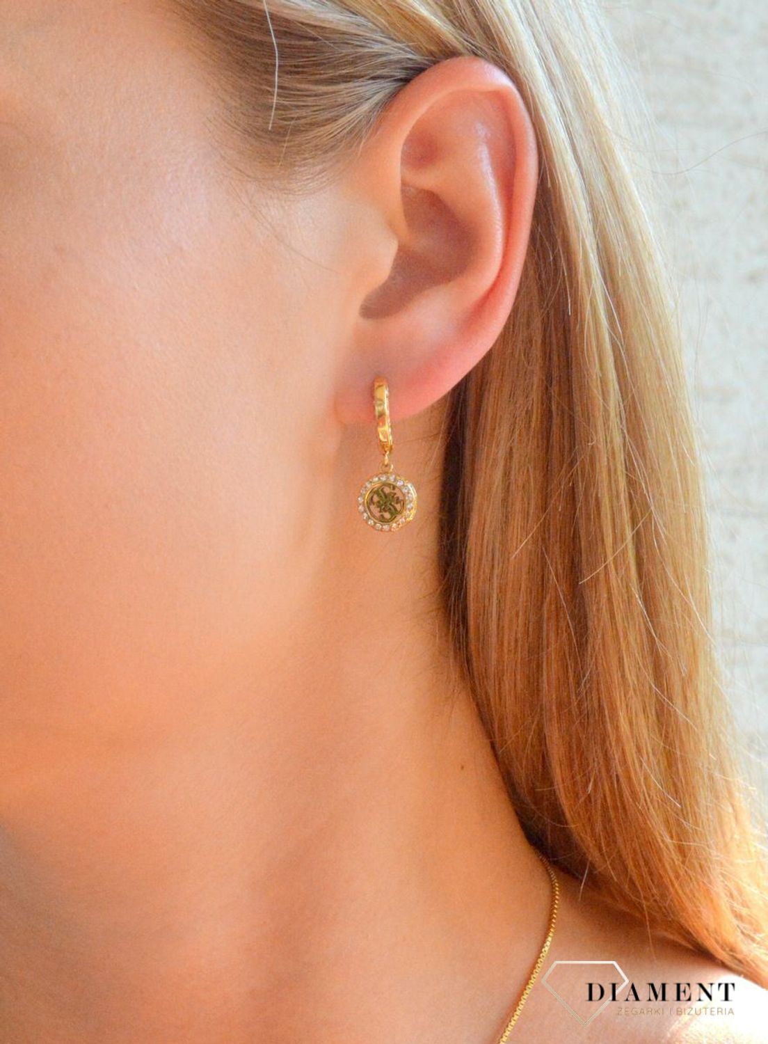 Złote kolczyki stalowe wiszące Guess JUBE04165JWYGT-U. Oryginalne kolczyki Guess. Złote kolczyki ze stali marki Guess. Kolczyki z Guessa na prezent. Stalowe kolczyki wiszące. Kolczyki damskie z logo Guess..jpg