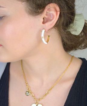 Pozłacane kolczyki Guess Bamboo 🤍 z białą emalią, logo GUESS i błyszczącą cyrkonią ✨. Długość 2,5 cm, zapięcie na sztyft – elegancki i modny wybór na co dzień i specjalne okazje 🎁 Model JUBE05156JWYGWHT-U (1).JPG