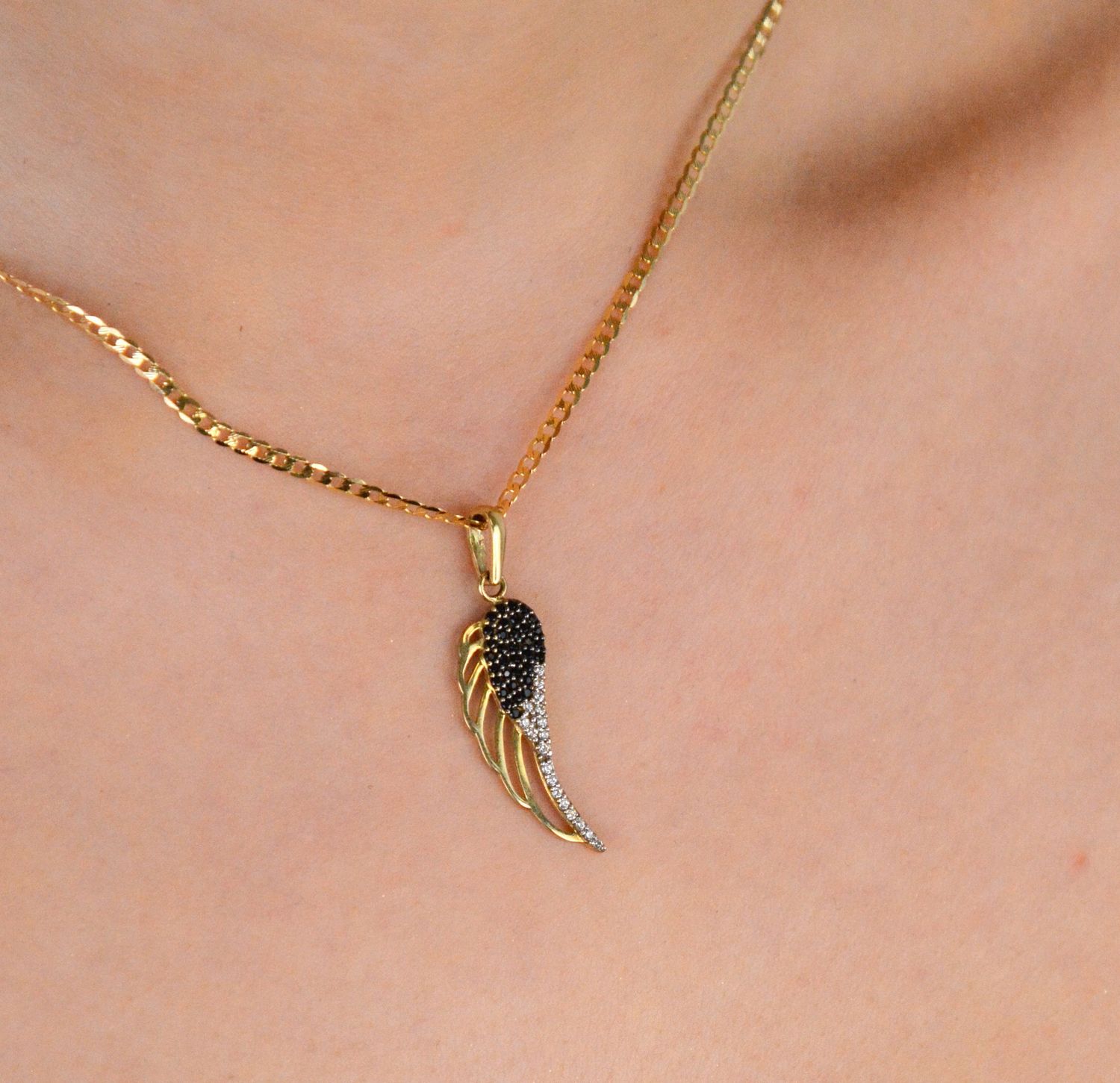 Złota zawieszka skrzydło z czarną i białą cyrkonią próba 333, OPZ000000-381. Symbol wolności, elegancji i blasku! 🕊️ Ta złota zawieszka w kształcie skrzydła jest ozdobiona kontrastującymi1.jpg