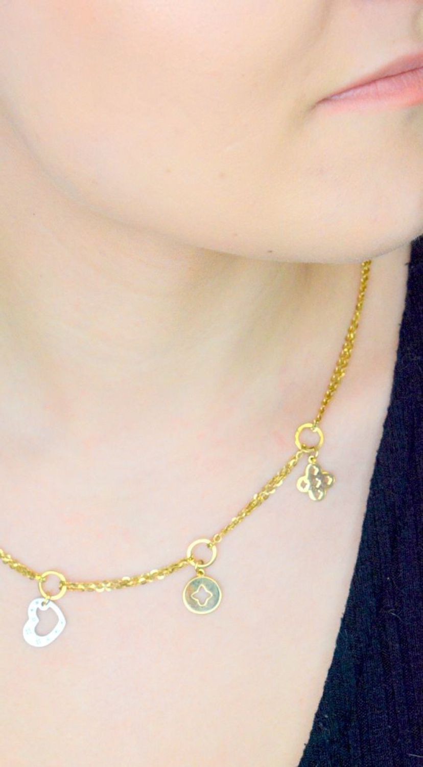 Złoty naszyjnik damski LV wiszące serce, kółko i koniczyny LV 585 OUN000000-039. Prezentowany złoty naszyjnik to doskonała propozycja dla kobiet, które cenią sobie uniwersalne i oryginalne 1.jpg