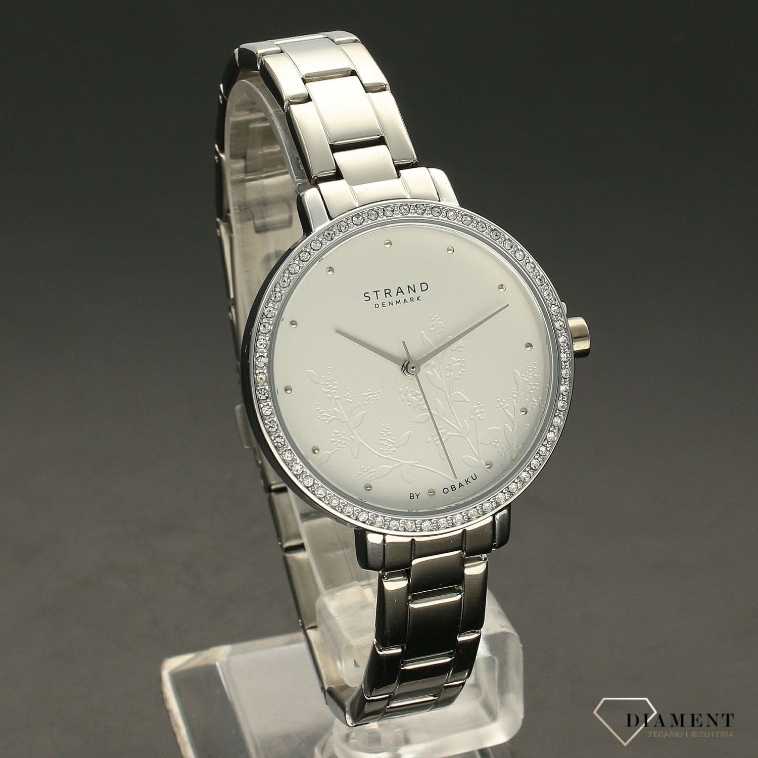 Zegarek damski STRAND Pacifica S712LXCISC. Strand Pacifica to elegancki zegarek damski z oryginalną, białą tarczą ozdobioną kwiatowym motywem. Zegarek damski posiada indeksy ze srebra. Tarcza ozdobiona jest błyszczą8.jpg